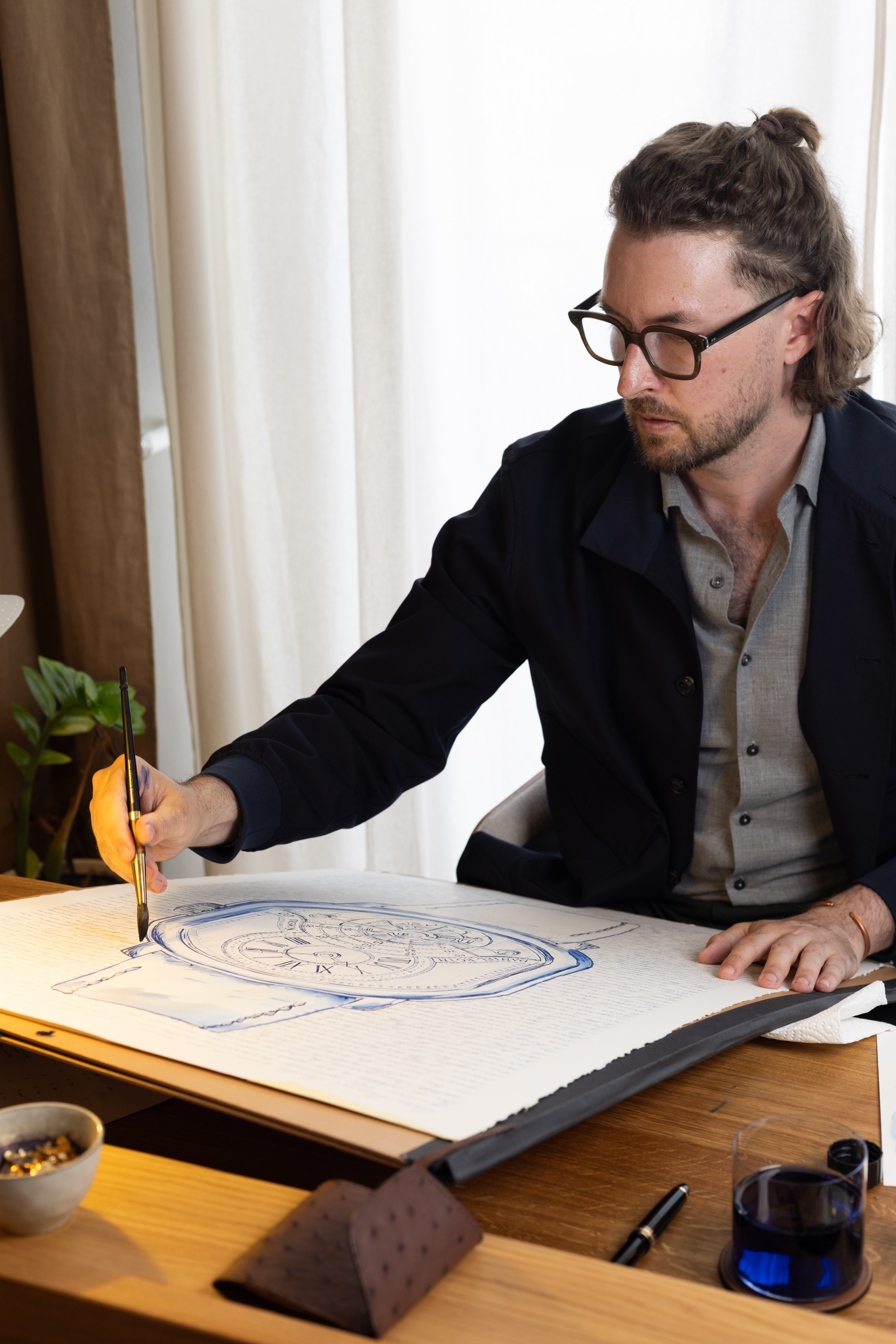 Mauro Carraro painting the large Daniel Roth Tourbillon artwork at his atelier desk.