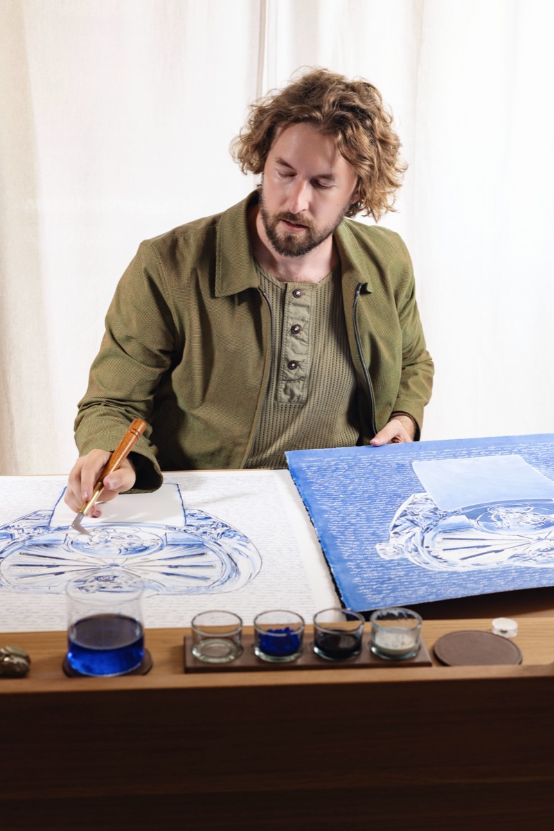 Mauro Carraro working on the ArtyA Complexity diptych, with both sheets on the table.