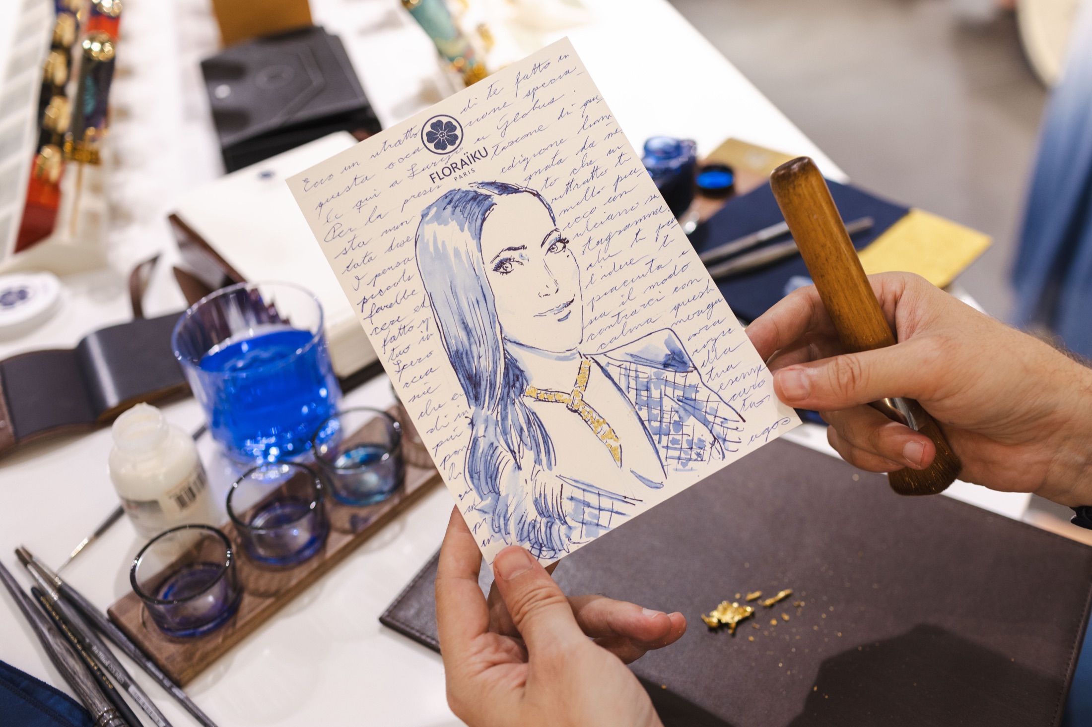 A completed blue-ink portrait made during the Floraïku activation at Globus Zurich.