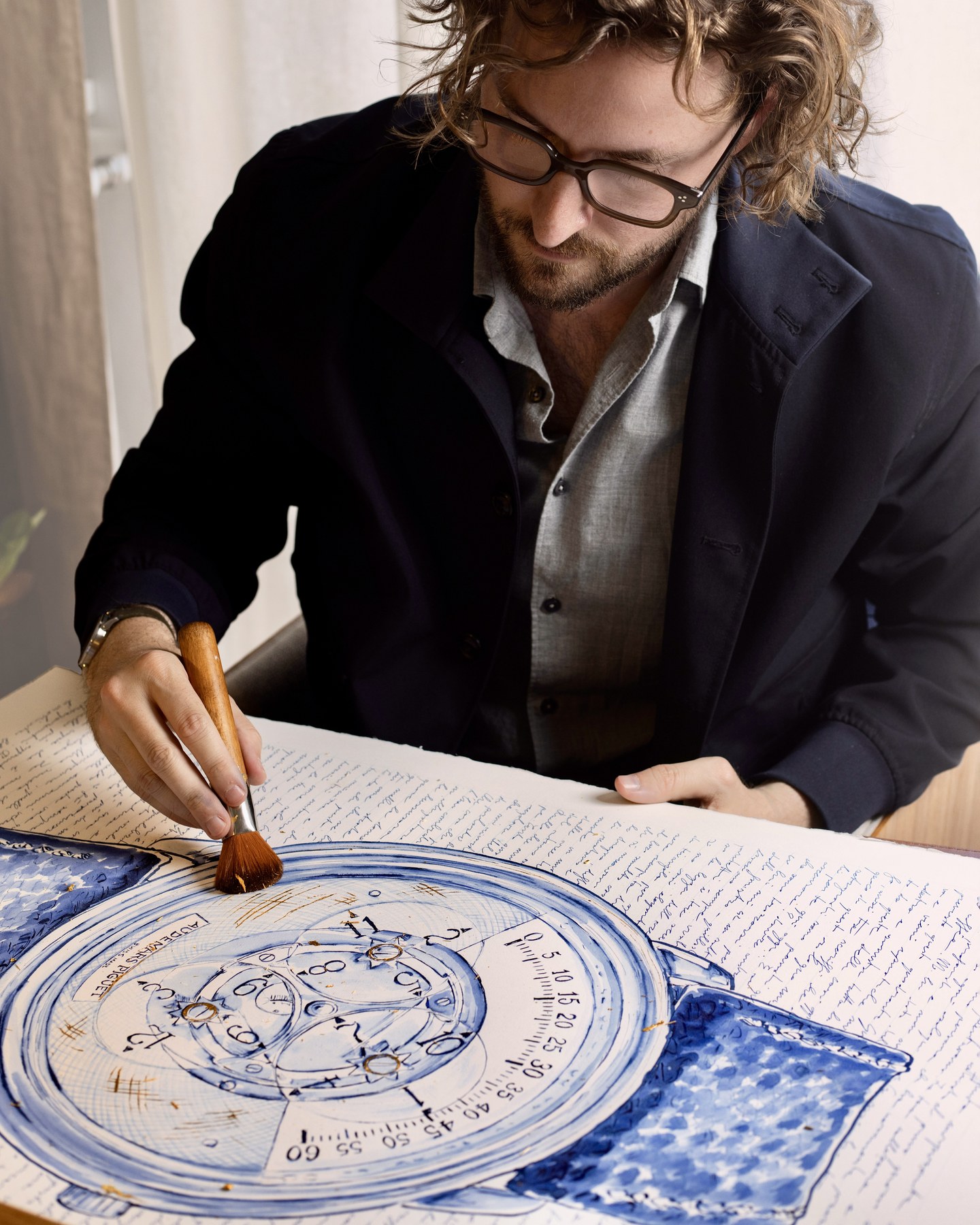 Mauro Carraro painting the large Audemars Piguet Star Wheel artwork at his atelier desk.