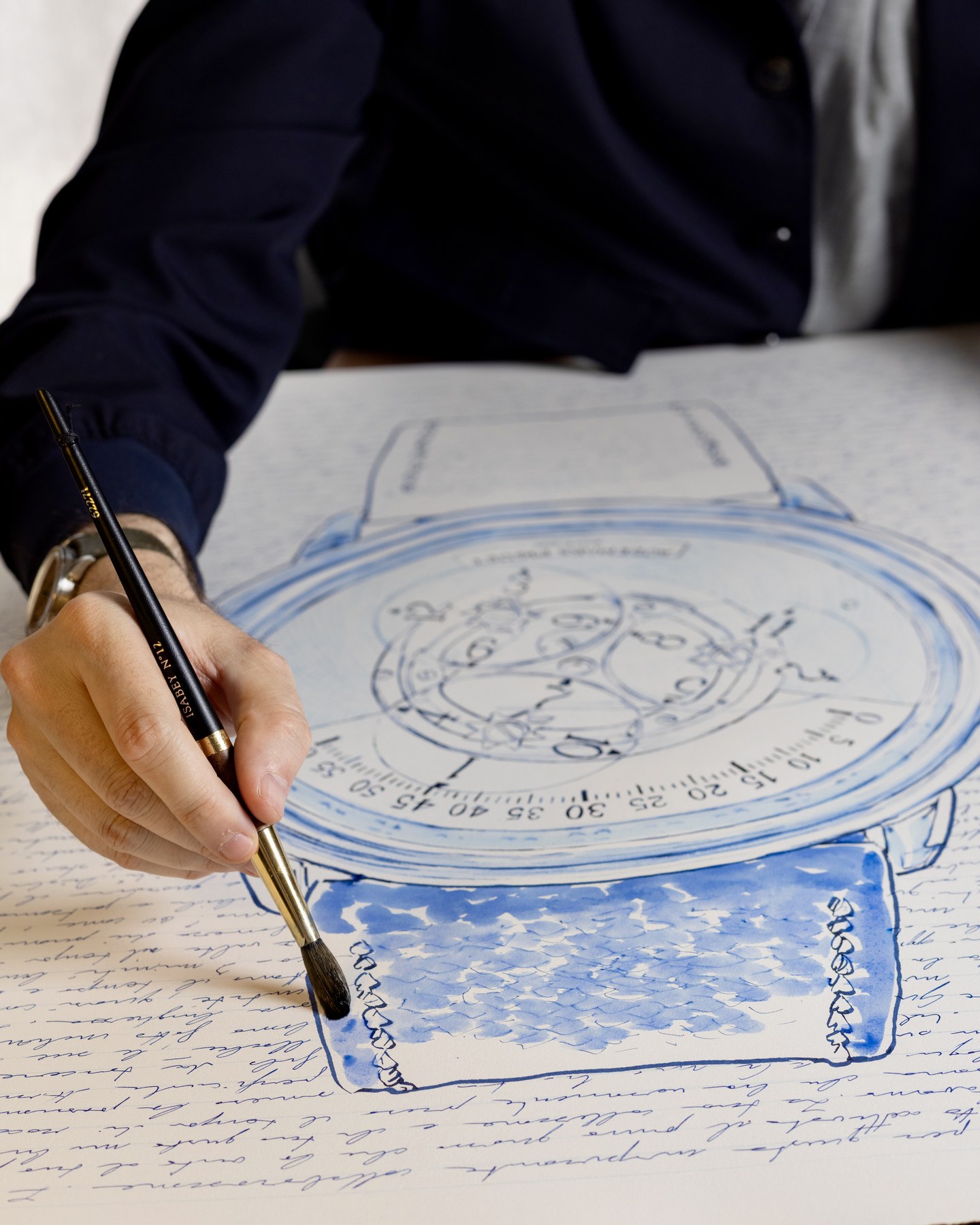 Mauro Carraro brushing blue ink onto the strap in the Star Wheel drawing.