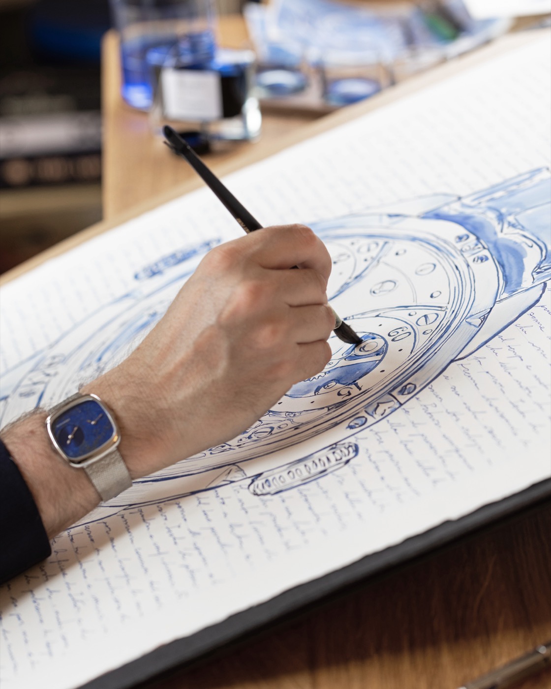A brush adding blue ink to the Chaykin Golden Mask dial drawing.