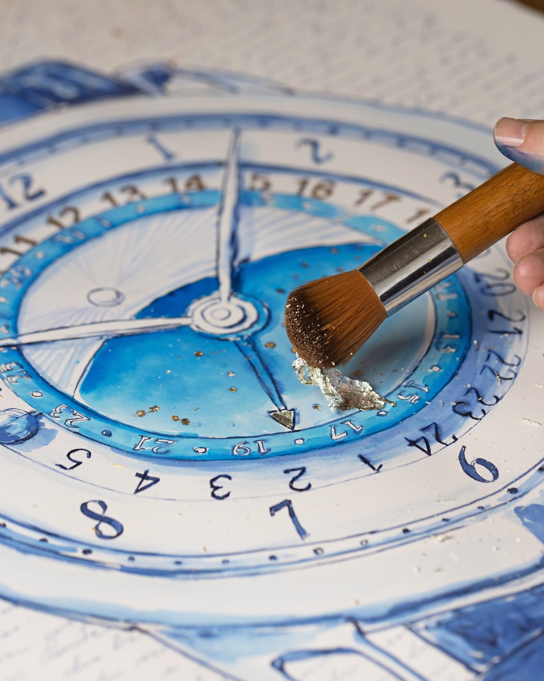 A broad brush touching reflective leaf on the blue De Bethune dial drawing.