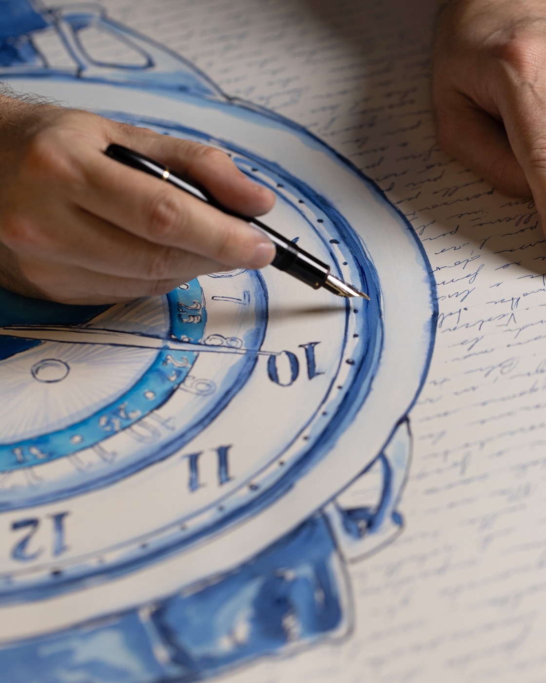 Mauro Carraro working on the watch drawing with a fountain pen, surrounded by handwriting.