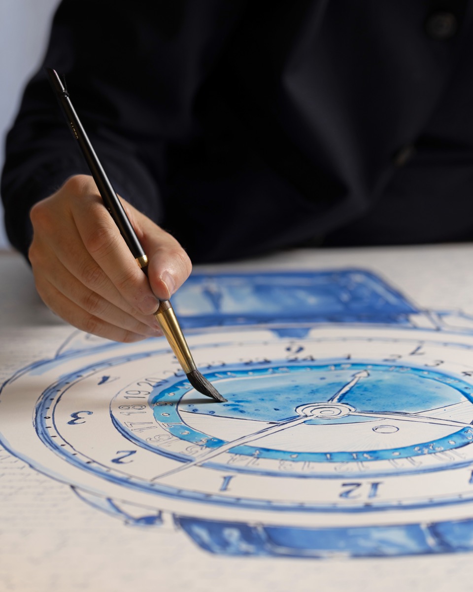 Mauro Carraro painting the blue dial with a fine brush.