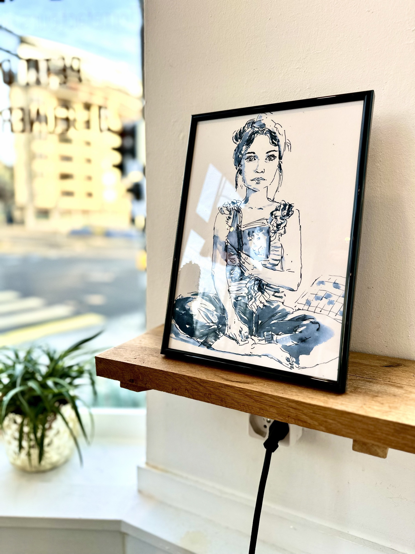 Blue-ink portrait in the Utopia Coffee exhibition.