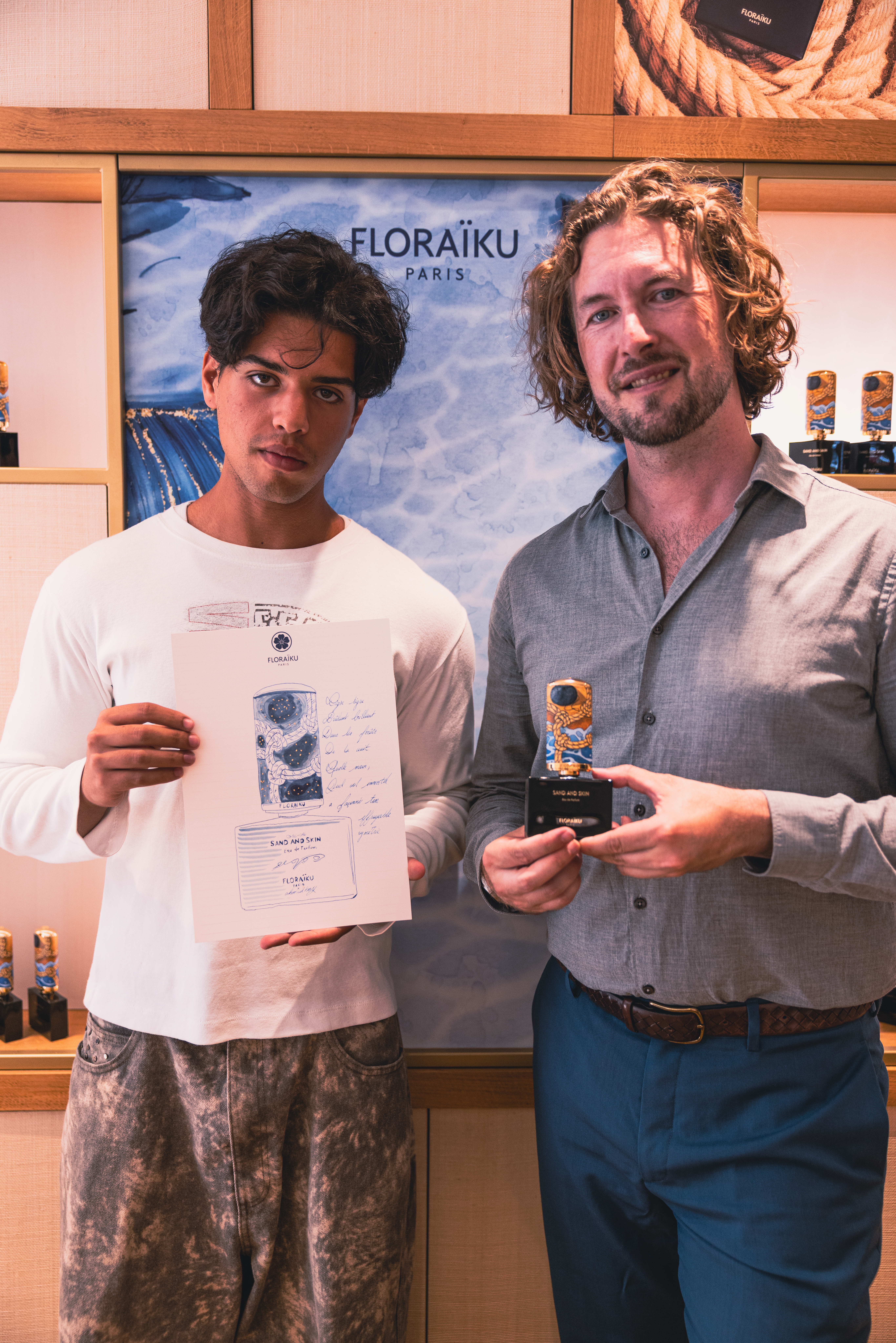 Mauro Carraro with a participant and a completed portrait at Floraïku Paris.