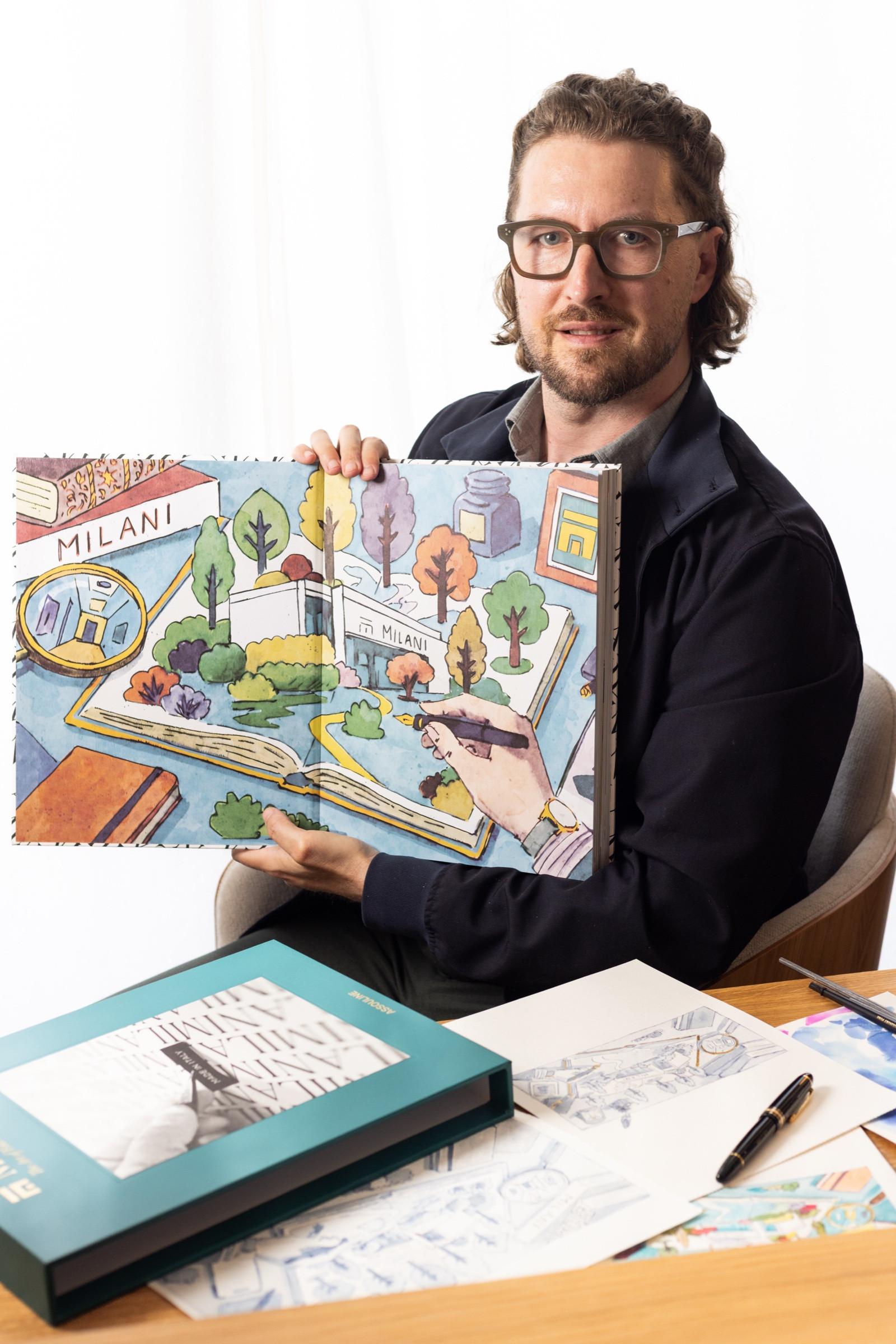 Mauro Carraro holding the completed Grafiche Milani anniversary book in the studio. Photograph by Johann Sauty.