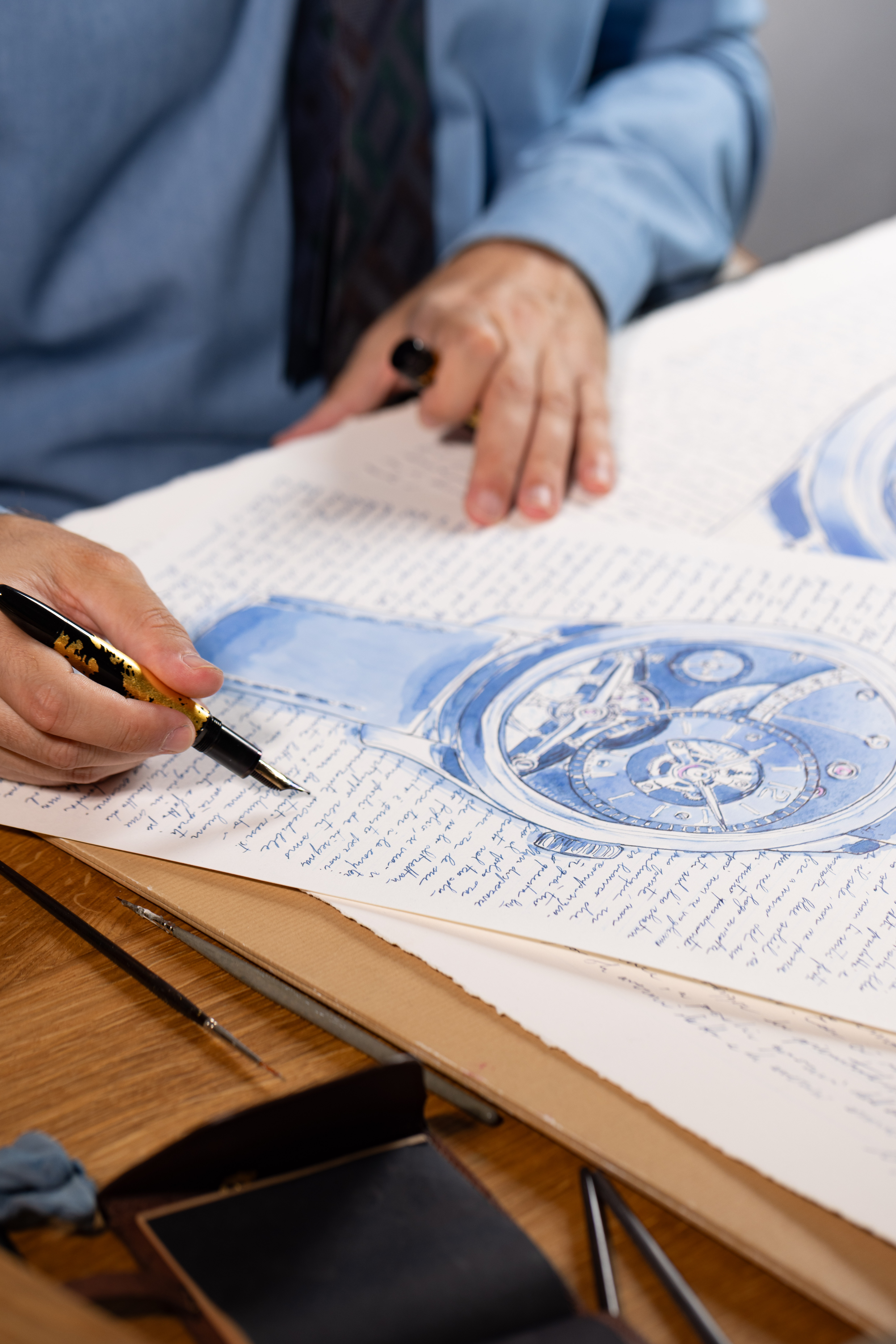 A fountain pen tracing the handwritten field of the work.