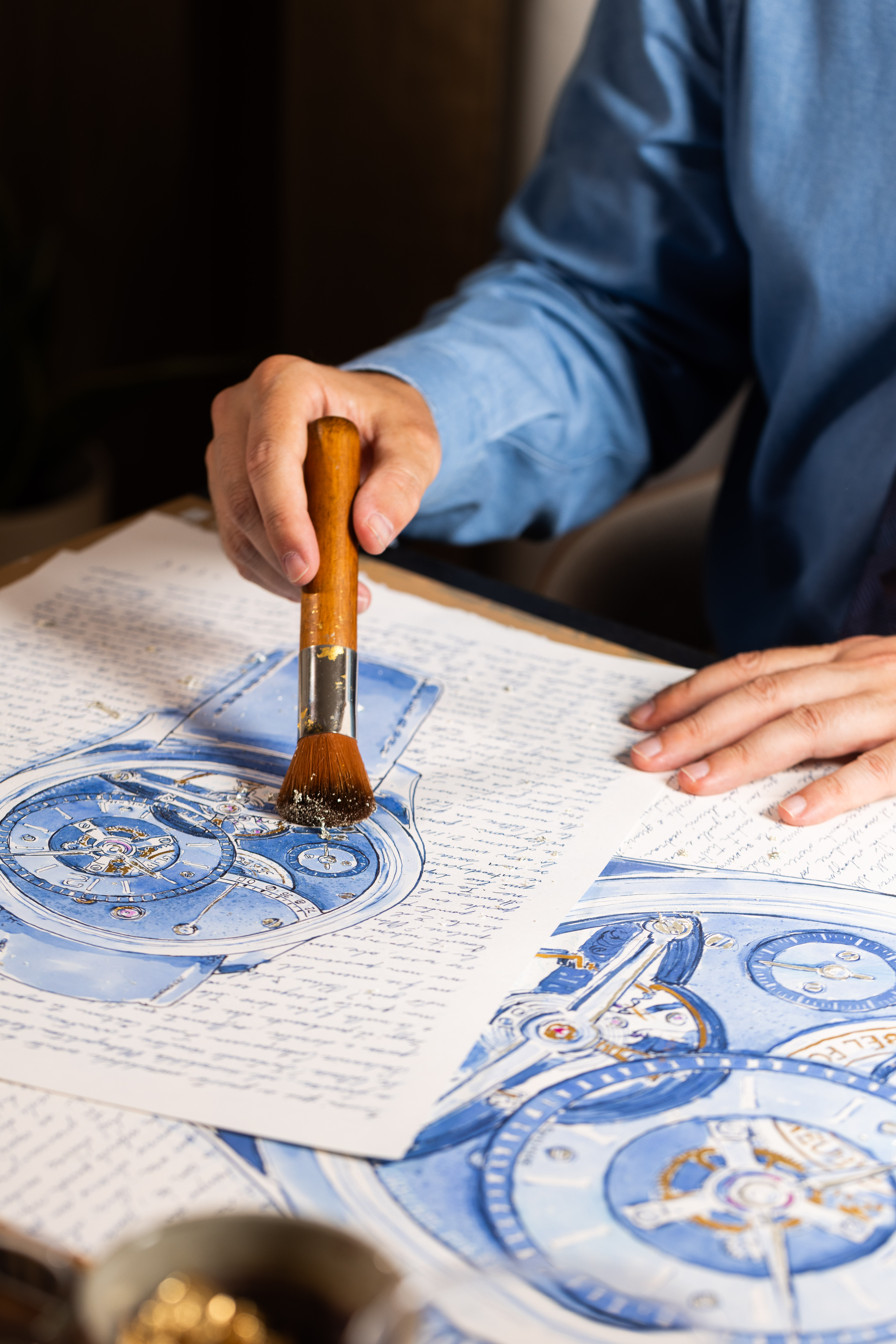 A quiet working gesture across the paper.