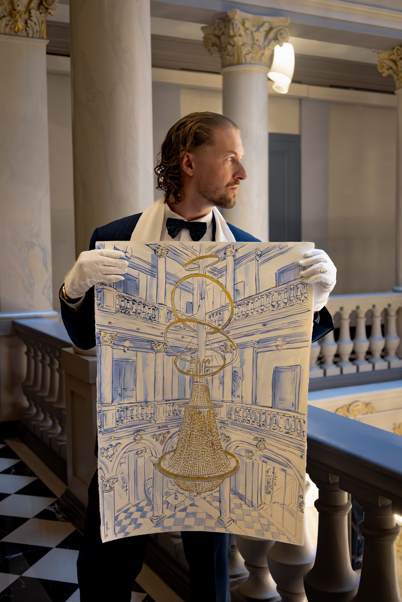 Mauro Carraro holding the chandelier drawing at The Ritz-Carlton Geneva.