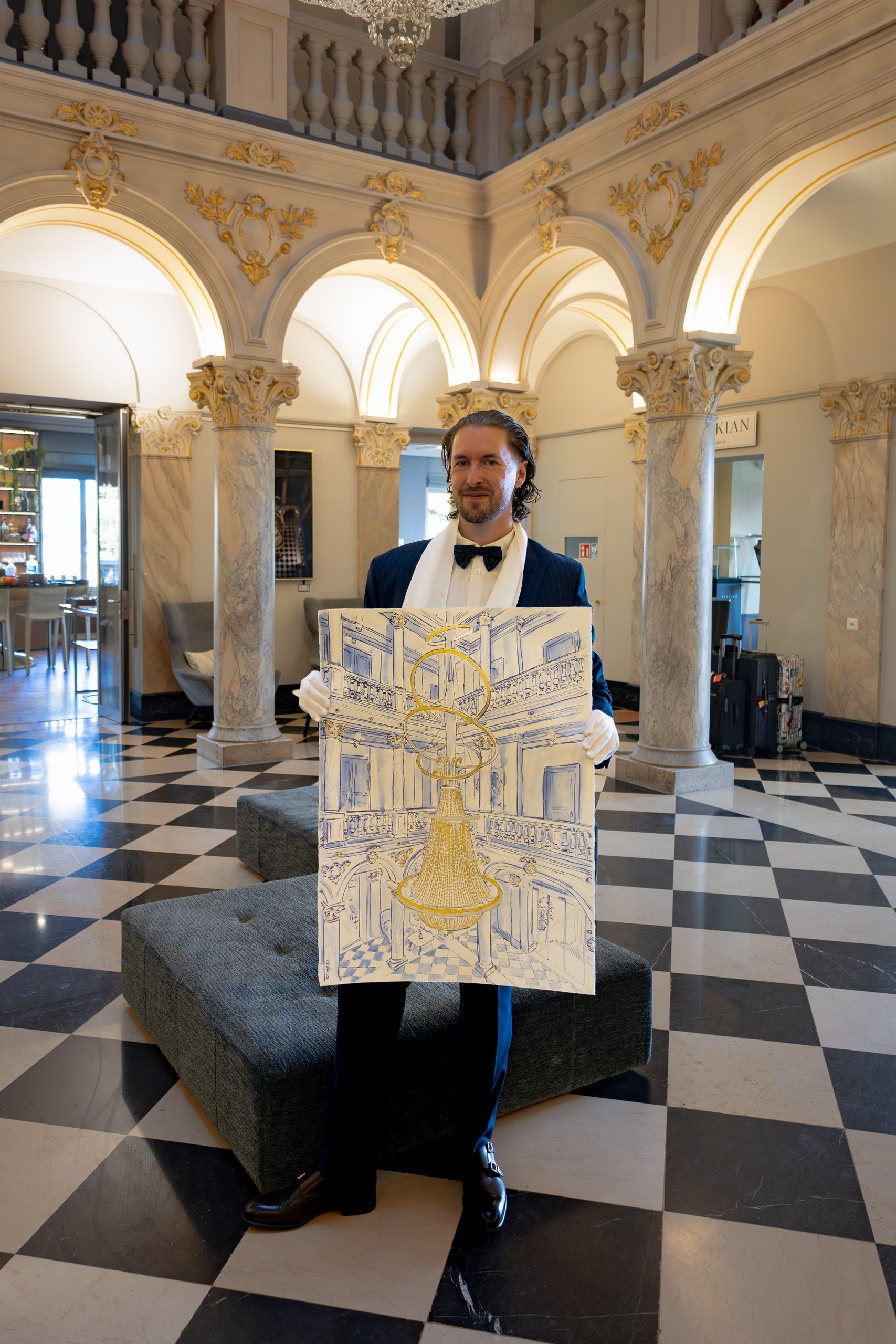 The live Ritz chandelier drawing surrounded by the anniversary setting.