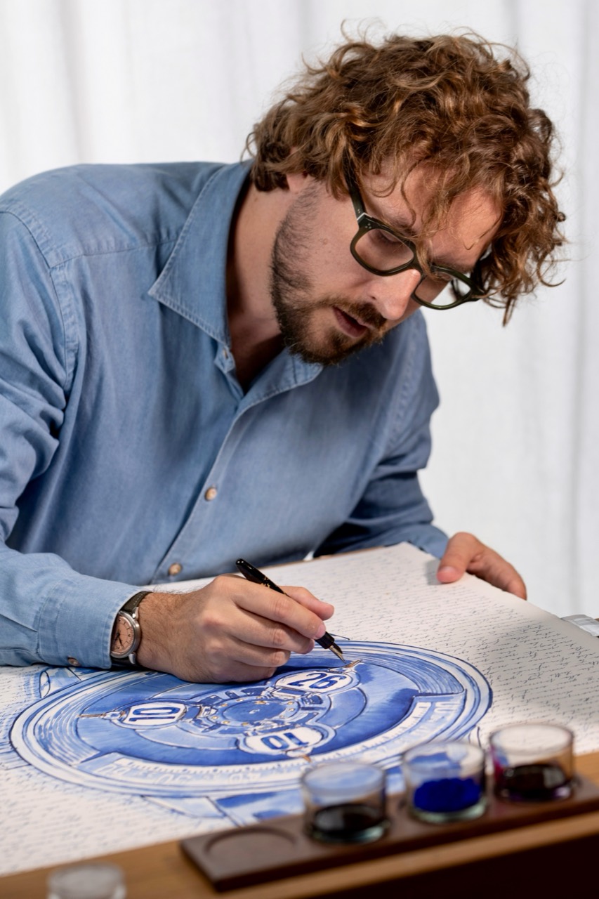 Mauro working with a fountain pen at the Studio table.