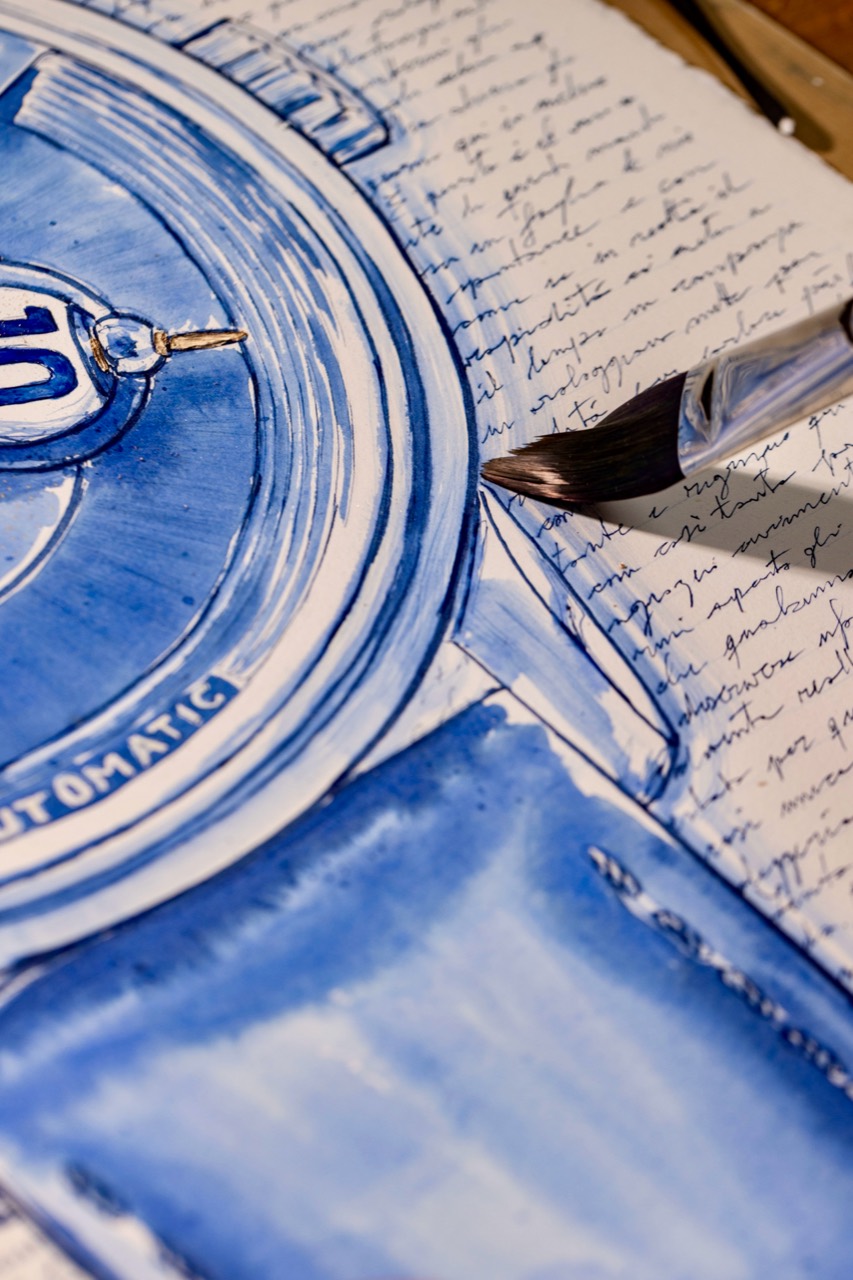 Blue watch strap and handwritten field on paper.