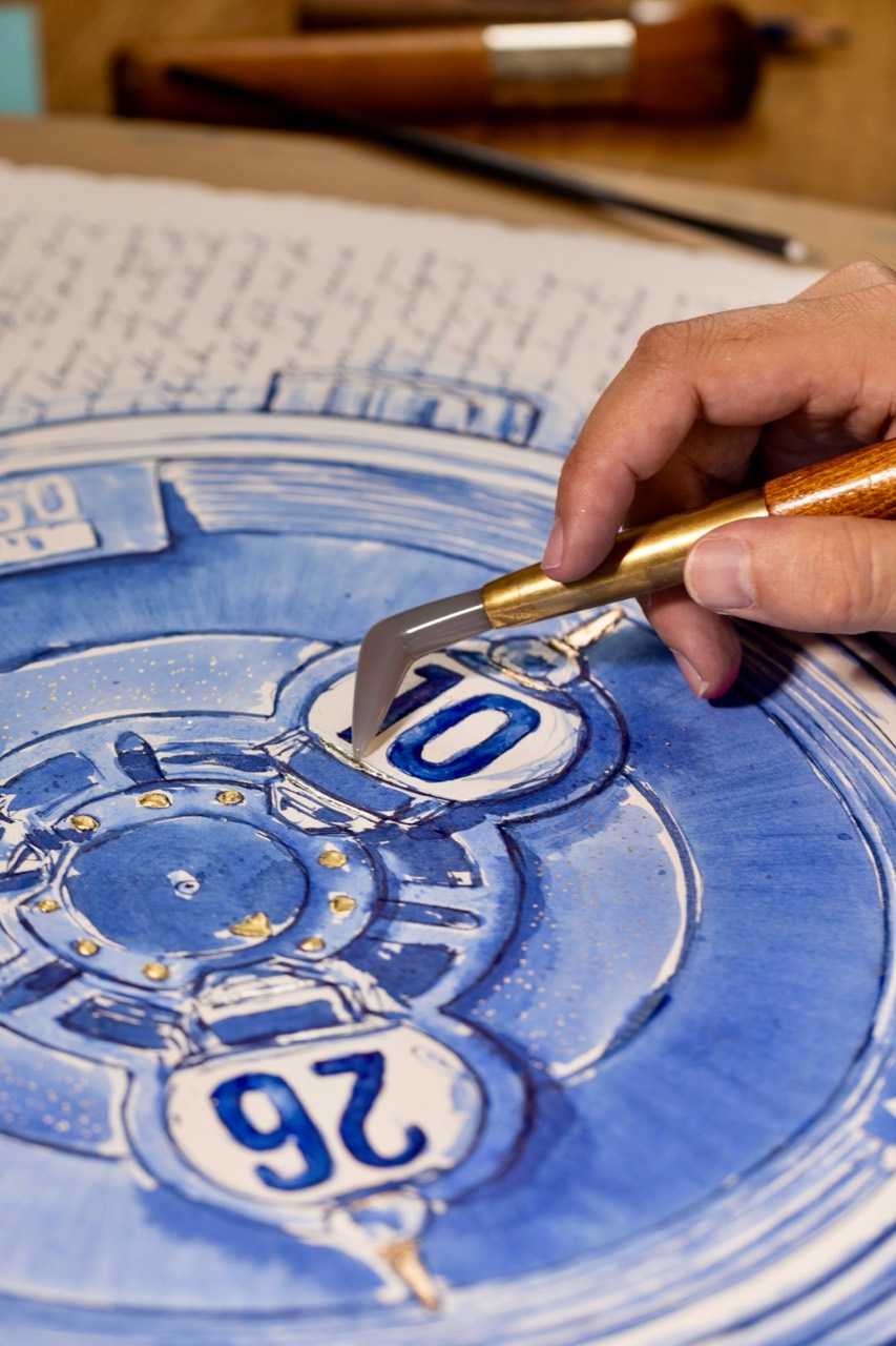 A tool held against a raised detail beside the numeral 10.